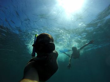 Couple swimming in sea