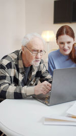 Senior man talking on video call with nurse at rehab center