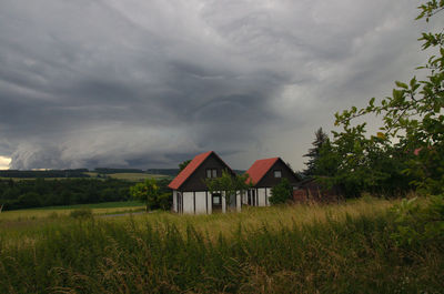 Built structure on field against sky