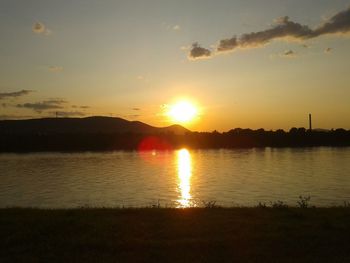 Scenic view of lake against sky during sunset