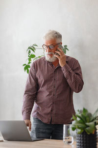 Man talking on mobile phone at office