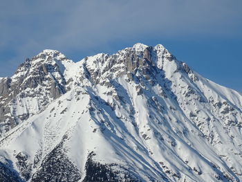 Scenic view of snow covered mountains against sky