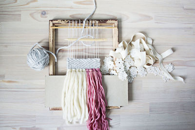 Directly above shot of knitting equipment on table