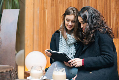 Young woman using smart phone outdoors