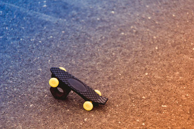 High angle view of toy skateboard with nut on street