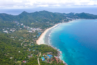 High angle view of sea and mountains against sky