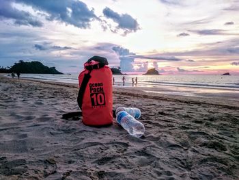 View of text on beach against sky during sunset