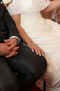 Midsection of couple holding hands
