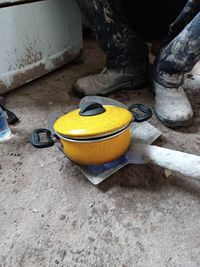 High angle view of yellow container on rock