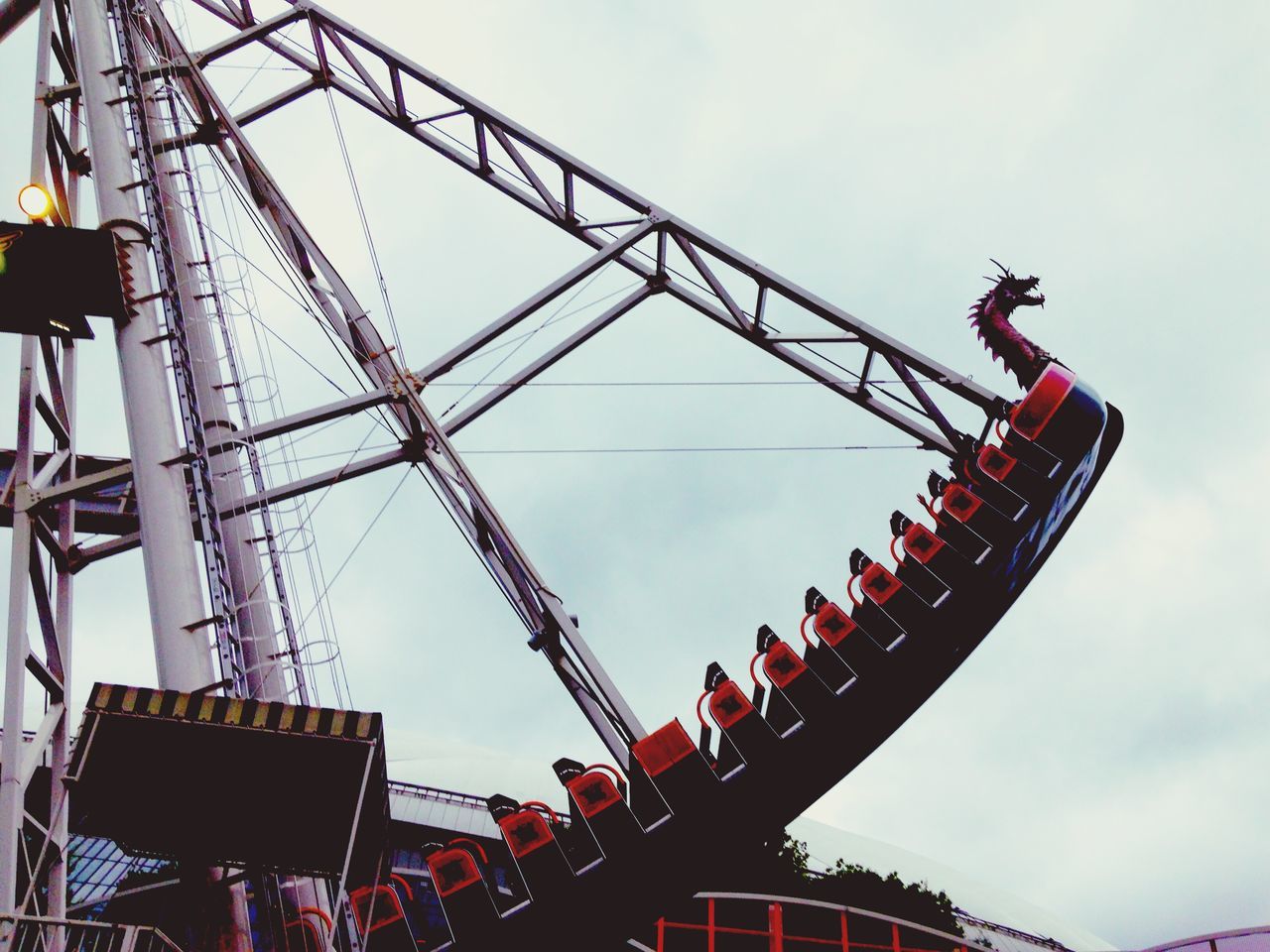 low angle view, amusement park, amusement park ride, arts culture and entertainment, sky, ferris wheel, built structure, architecture, fun, metal, crane - construction machinery, chain swing ride, outdoors, enjoyment, day, cloud - sky, construction site, clear sky, no people, development