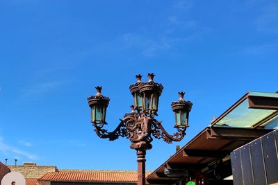 Low angle view of street light against building