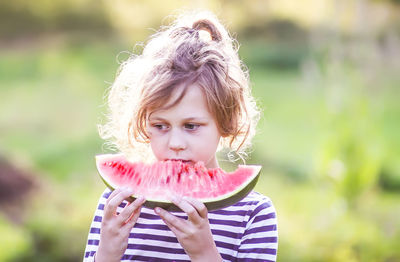 Portrait of child eating watermelon