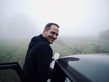 Portrait of smiling mid adult man in car