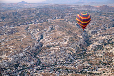 Aerial view of hot air balloon flying over rocks, turkey
