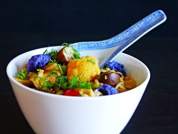 Close-up of food in bowl against black background