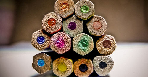Close-up of multi colored pencils on table