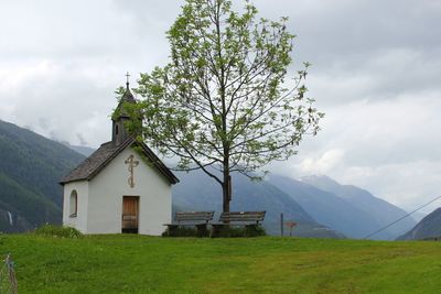 Scenic view of grassy field against cloudy sky