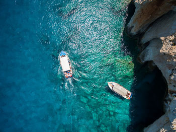 High angle view of people swimming in sea