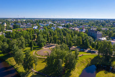 High angle view of trees and cityscape against sky