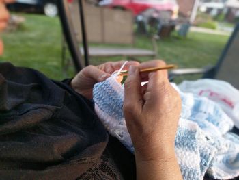 Close-up of hand holding cigarette
