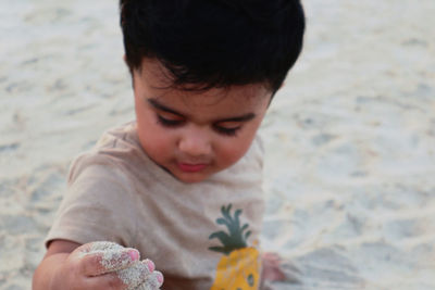 Cute boy on sand at kite beach