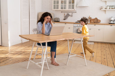 People sitting on table at home