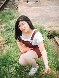 Young woman sitting on field