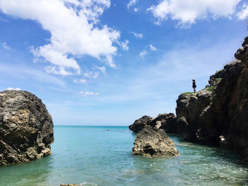 Rock formation in sea against sky