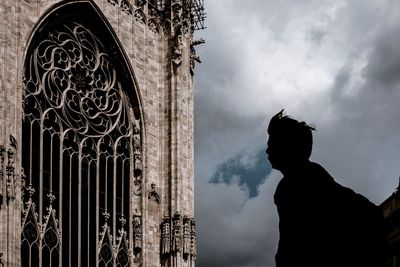 Low angle view of silhouette statue against sky