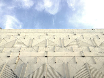 Low angle view of building against cloudy sky