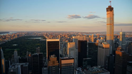 Aerial view of buildings in city during sunset