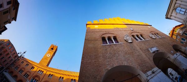 Low angle view of bell tower against sky