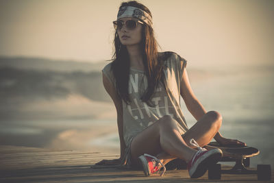 Beautiful young girl with her skateboard