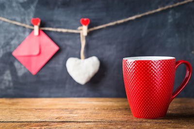 Close-up of heart shape coffee cup on table