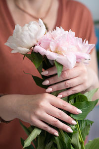 Girl's hands with a beautiful pink manicure design,pastel color, gently, flowers