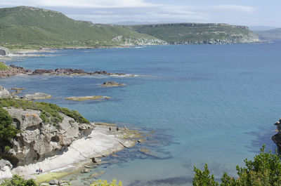 High angle view of sea and mountains against sky