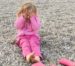 Full length of girl with pink petals