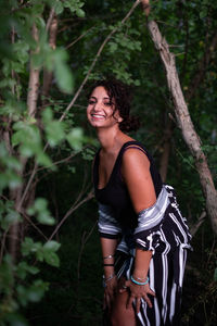 Happy young woman in forest