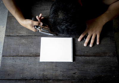 Midsection of woman sitting on table