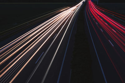 Light trails on road in city at night