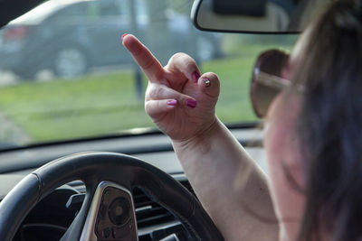 Midsection of woman in car