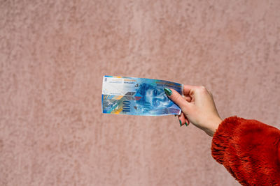 Close-up of person holding paper