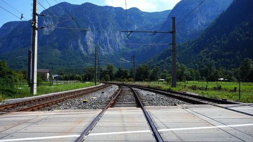 Diminishing perspective of railroad tracks against mountains