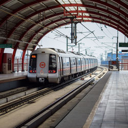 Delhi metro train arriving at metro station in new delhi, india, asia, public metro departing