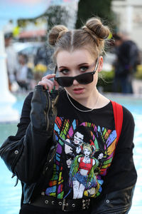 Portrait of woman wearing sunglasses standing outdoors