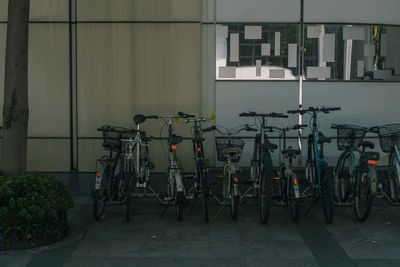 Bicycles parked against building in city
