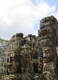 Statue of temple against cloudy sky