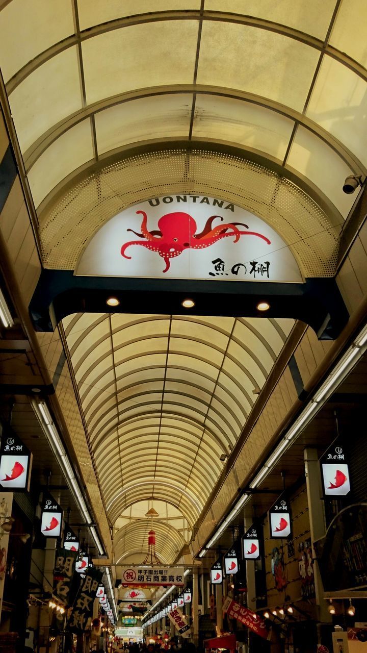 LOW ANGLE VIEW OF ILLUMINATED TEXT ON CEILING