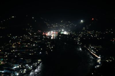 High angle view of illuminated city buildings at night