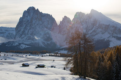 Scenic view of snow covered land and mountains against sky